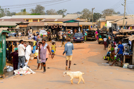 CENTRAL REGION, GHANA - Jan 17, 2017: Unidentified Ghanaian people walk  along the market in local village. People of Ghana suffer of poverty due to the bad economyのeditorial素材
