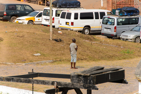 ELMINA, GHANA -JAN 18, 2017: Unidentified  Ghanaian man stands from behind on the coast of Elmina. People of Ghana suffer of poverty due to the bad economyのeditorial素材