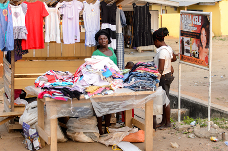 CENTRAL REGION, GHANA - Jan 17, 2017: Unidentified Ghanaian woman sells clothes in local village. People of Ghana suffer of poverty due to the bad economyのeditorial素材