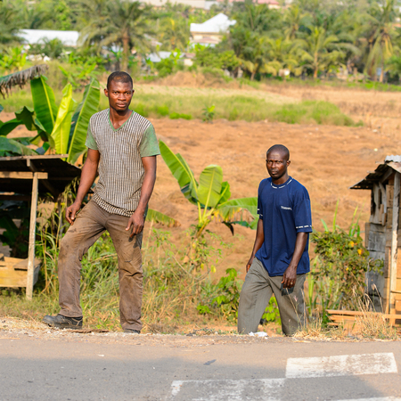 CENTRAL REGION, GHANA - Jan 17, 2017: Unidentified Ghanaian people walk near the road in local village. People of Ghana suffer of poverty due to the bad economyのeditorial素材