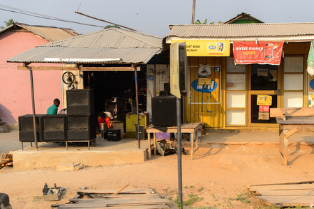 CENTRAL REGION, GHANA - Jan 17, 2017: Unidentified Ghanaian man stands behind subwoofers in local village. People of Ghana suffer of poverty due to the bad economyのeditorial素材