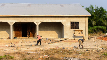 CENTRAL REGION, GHANA - Jan 17, 2017: Unidentified Ghanaian men work on the street in local village. People of Ghana suffer of poverty due to the bad economyのeditorial素材