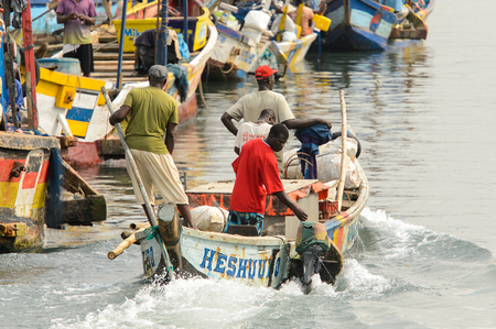 ELMINA, GHANA -JAN 18, 2017: Unidentified  Ghanaian people sail on the boats in Elmina port. People of Ghana suffer of poverty due to the bad economyのeditorial素材