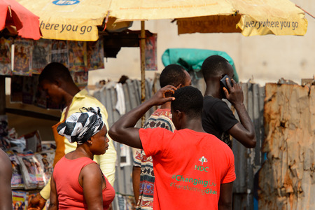 ELMINA, GHANA -JAN 18, 2017: Unidentified  Ghanaian people stand in queue near the press stall. People of Ghana suffer of poverty due to the bad economyのeditorial素材