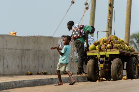 ELMINA, GHANA -JAN 18, 2017: Unidentified  Ghanaian little boy walks with bread in his hands in Elmina. Children of Ghana suffer of poverty due to the bad economyのeditorial素材