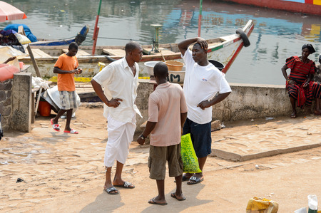 ELMINA, GHANA -JAN 18, 2017: Unidentified  Ghanaian men talk about something in Elmina. People of Ghana suffer of poverty due to the bad economyのeditorial素材