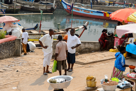 ELMINA, GHANA -JAN 18, 2017: Unidentified  Ghanaian men stand on the road in Elmina. People of Ghana suffer of poverty due to the bad economyのeditorial素材