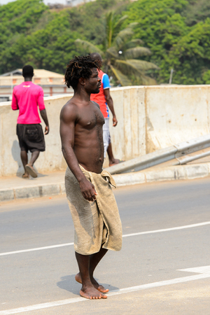 ELMINA, GHANA -JAN 18, 2017: Unidentified  Ghanaian man walks along the street in Elmina port. People of Ghana suffer of poverty due to the bad economyのeditorial素材
