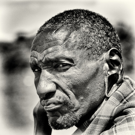 KENYA - OCTOBER 10, 2009: Portrait of an unidentified old serious Massai wearing typical tribal clothes in Kenya, Oct 10, 2009. Massai people are a Nilotic ethnic groupのeditorial素材