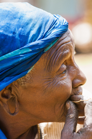 AMBOSELI, KENYA - OCTOBER 10, 2009: Unidentified Massai old woman in a blue kerchief in Kenya, Oct 10, 2009. Massai people are a Nilotic ethnic groupのeditorial素材
