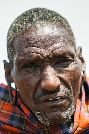 KENYA - OCTOBER 10, 2009: Portrait of an unidentified old serious Massai wearing typical tribal clothes in Kenya, Oct 10, 2009. Massai people are a Nilotic ethnic groupのeditorial素材