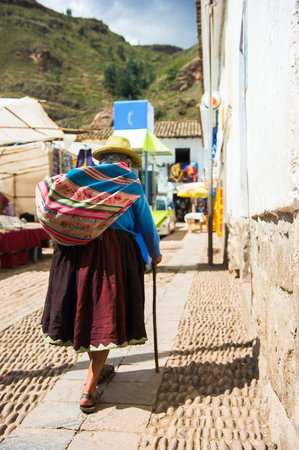 PERU - NOVEMBER 3, 2010: Unidentified Peruvian lady in the popular bowler hat walks the street in Peru, Nov 3, 2010. Over 50 per cent of people in Peru live below the the poverty line.のeditorial素材