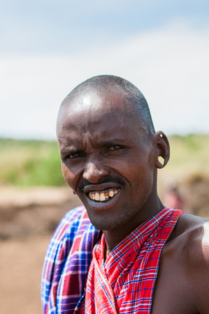 KENYA - OCTOBER 10, 2009: Portrait of an unidentified Massai smiling man in typical tribal clothes in Kenya, Oct 10, 2009. Massai people are a Nilotic ethnic groupのeditorial素材