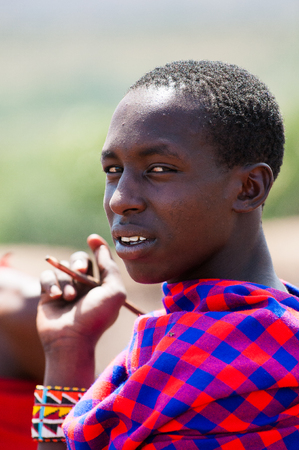 KENYA - OCTOBER 10, 2009: Unidentified Massai man walks wearing typical tribal clothes in Kenya, Oct 10, 2009. Massai people are a Nilotic ethnic groupのeditorial素材