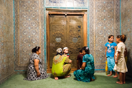KHIVA, UZBEKISTAN - JUNE 4, 2011: Unidentified Uzbek people sit near the door in Uzbekistan, Jun 4, 2011.  81% of people in Uzbekistan belong to Uzbek ethnic groupのeditorial素材