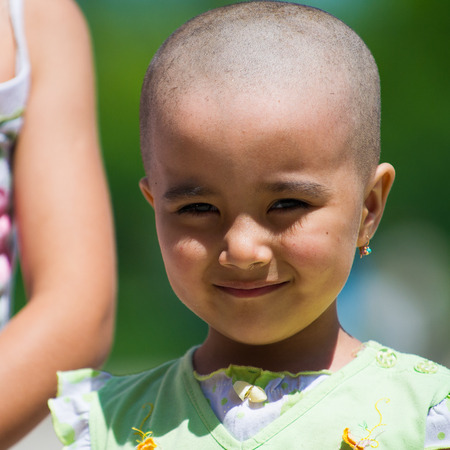 TASHKENT, UZBEKISTAN - JUNE 12, 2011: Unidentified Uzbek girl smiles for the camera in Uzbekistan, Jun 12, 2011. 81% of people in Uzbekistan belong to Uzbek ethnic groupのeditorial素材