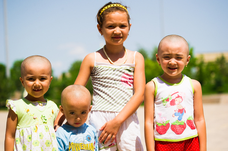 TASHKENT, UZBEKISTAN - JUNE 12, 2011: Unidentified Uzbek girls smiles for the camera in Uzbekistan, Jun 12, 2011. 81% of people in Uzbekistan belong to Uzbek ethnic groupのeditorial素材