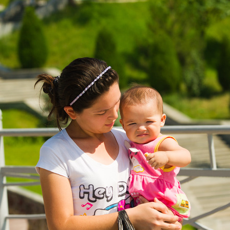 TASHKENT, UZBEKISTAN - JUNE 12, 2011: Unidentified Uzbek woman holds her little baby in Uzbekistan, Jun 12, 2011.  81% of people in Uzbekistan belong to Uzbek ethnic groupのeditorial素材