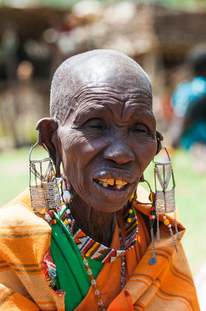 AMBOSELI, KENYA - OCTOBER 10, 2009: Portrait of an unidentified Massai extraordinary woman with heavy earings in Kenya, Oct 10, 2009. Massai people are a Nilotic ethnic groupのeditorial素材