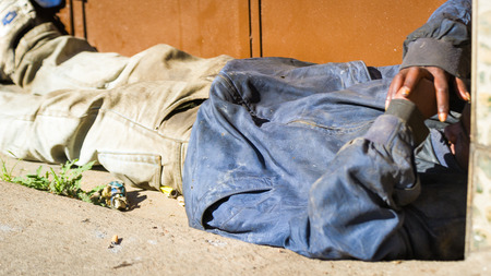 ANTANANARIVO, MADAGASCAR - JUNE 27, 2011: Unidentified Madagascar homeless man sleep on the road. People in Madagascar suffer of poverty due to the slow development of the countryのeditorial素材