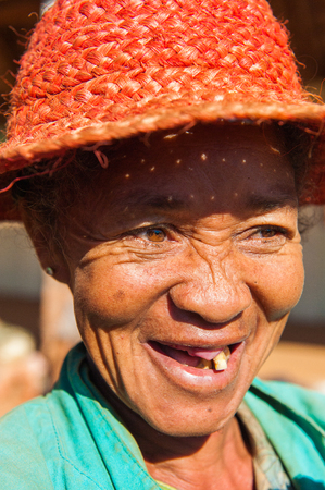 MADAGASCAR - JULY 1, 2011: Portrait of an unidentified woman in a red hat in Madagascar, July 1, 2011. People of Madagascar suffer of poverty due to the unstable situation.のeditorial素材
