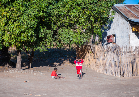 ANTANANARIVO, MADAGASCAR - JULY 1, 2011: Unidentified Madagascar children in the street near the house. People in Madagascar suffer of poverty due to slow development of the countryのeditorial素材