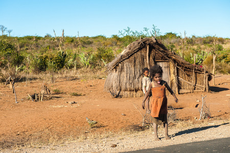 ANTANANARIVO, MADAGASCAR - JULY 3, 2011: Unidentified Madagascar children near a wooden house....
