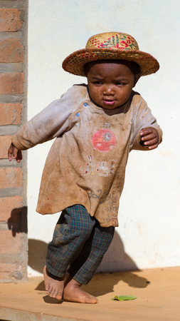 ANTANANARIVO, MADAGASCAR - JULY 1, 2011: Unidentified Madagascar boy runs in the street. People in Madagascar suffer of poverty due to slow development of the countryのeditorial素材