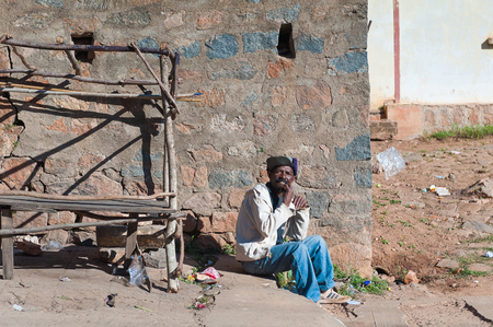 ANTANANARIVO, MADAGASCAR - JUNE 30, 2011: Unidentified Madagascar mansits near a stone house.  People in Madagascar suffer of poverty due to slow development of the countryのeditorial素材