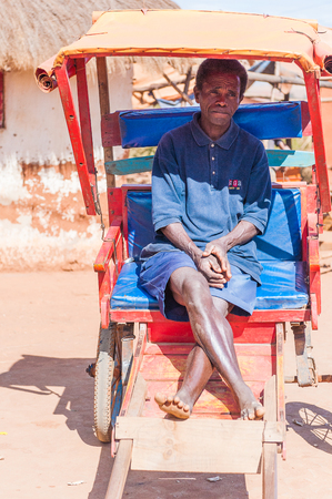 ANTANANARIVO, MADAGASCAR - JULY 1, 2011: Unidentified Madagascar man sits in a carriage. People in Madagascar suffer of poverty due to slow development of the countryのeditorial素材