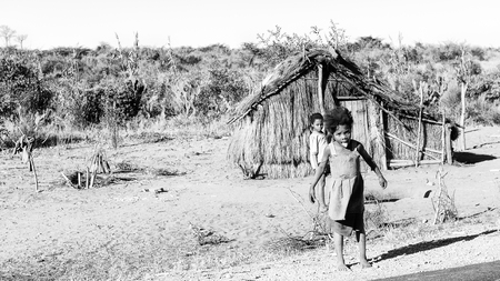 ANTANANARIVO, MADAGASCAR - JULY 3, 2011: Unidentified Madagascar children near a wooden house. People in Madagascar suffer of poverty due to slow development of the countryのeditorial素材