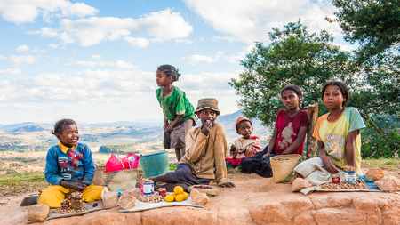 ANTANANARIVO, MADAGASCAR - JUNE 30, 2011: Unidentified Madagascar children play  and eat in the street.  People in Madagascar suffer of poverty due to slow development of the countryのeditorial素材