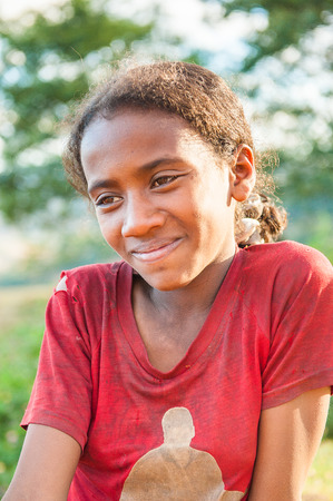 MADAGASCAR - JUNE 30, 2011: Portrait of an unidentified girl smiling for the camera in Madagascar, June 30, 2011. Children of Madagascar suffer of poverty due to the unstable situation.のeditorial素材