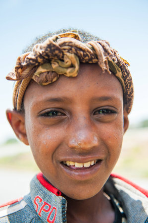 OMO VALLEY, ETHIOPIA - SEP 19, 2011: Portrait of an unidentified Ethiopian boy in Ethiopia, Sep.19, 2011. People in Ethiopia suffer of poverty due to the unstable situationのeditorial素材