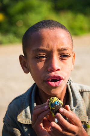 OMO VALLEY, ETHIOPIA - SEP 22, 2011: Unidentified Ethiopianboy smiles for the camera  in Ethiopia, Sep.22, 2011. People in Ethiopia suffer of poverty due to the unstable situationのeditorial素材