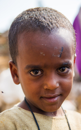 OMO VALLEY, ETHIOPIA - SEP 22, 2011: Unidentified Ethiopianboy smiles for the camera  in Ethiopia, Sep.22, 2011. People in Ethiopia suffer of poverty due to the unstable situationのeditorial素材