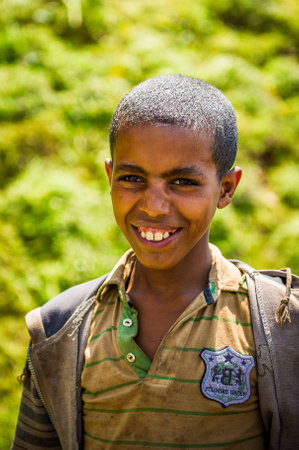 OMO, ETHIOPIA - SEPTEMBER 19, 2011: Unidentified Ethiopian boy smiles. People in Ethiopia suffer of poverty due to the unstable situationのeditorial素材