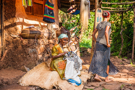 OMO, ETHIOPIA - SEPTEMBER 20, 2011: Unidentified Ethiopian woman is sewing. People in Ethiopia...