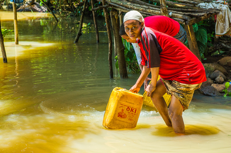 OMO, ETHIOPIA - SEPTEMBER 20, 2011: Unidentified Ethiopian women getting water. People in Ethiopia suffer of poverty due to the unstable situationのeditorial素材