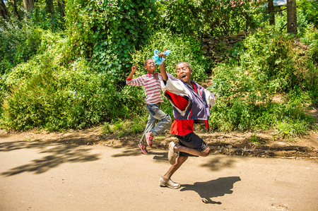 OMO, ETHIOPIA - SEPTEMBER 21, 2011: Unidentified Ethiopian boy runs in the street. People in Ethiopia suffer of poverty due to the unstable situationのeditorial素材