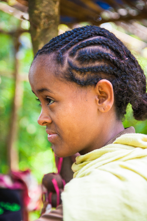 OMO VALLEY, ETHIOPIA - SEP 20, 2011: Unidentified Ethiopian shy gir in a traditional dress in Ethiopia, Sep.20, 2011. People in Ethiopia suffer of poverty due to the unstable situationのeditorial素材