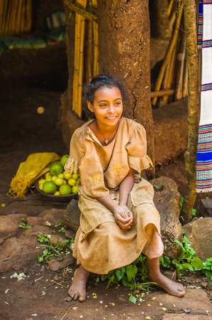 OMO, ETHIOPIA - SEPTEMBER 20, 2011: Unidentified Ethiopian young girl near her house. People in...