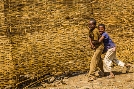 OMO, ETHIOPIA - SEPTEMBER 21, 2011: Unidentified Ethiopian boys play in the street. People in Ethiopia suffer of poverty due to the unstable situationのeditorial素材