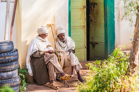 OMO, ETHIOPIA - SEPTEMBER 21, 2011: Unidentified Ethiopian old men in white tissue. People in Ethiopia suffer of poverty due to the unstable situationのeditorial素材
