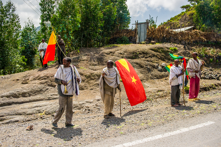OMO, ETHIOPIA - SEPTEMBER 21, 2011: Unidentified Ethiopian men walk on the road. People in Ethiopia suffer of poverty due to the unstable situationのeditorial素材