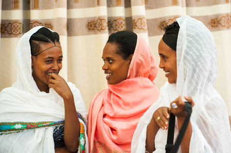AKSUM, ETHIOPIA - SEPTEMBER 24, 2011: Unidentified Ethiopian young girls smile wearing different...