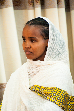 AKSUM, ETHIOPIA - SEPTEMBER 24, 2011: Unidentified Ethiopian young girl with a white tissue. People in Ethiopia suffer of poverty due to the unstable situationのeditorial素材