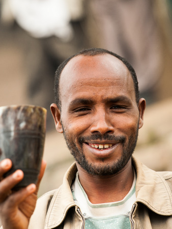 OMO VALLEY, ETHIOPIA - SEP 22, 2011: Unidentified Ethiopian man offers the stuff to buy in Ethiopia, Sep.22, 2011. People in Ethiopia suffer of poverty due to the unstable situationのeditorial素材