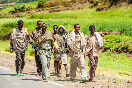 OMO, ETHIOPIA - SEPTEMBER 21, 2011: Unidentified Ethiopian men walk on the road. People in Ethiopia suffer of poverty due to the unstable situationのeditorial素材