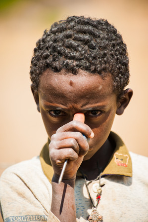 AKSUM, ETHIOPIA - SEP 24, 2011: Unidentified Ethiopian young man smiles in Ethiopia, Sep.24, 2011. People in Ethiopia suffer of poverty due to the unstable situationのeditorial素材